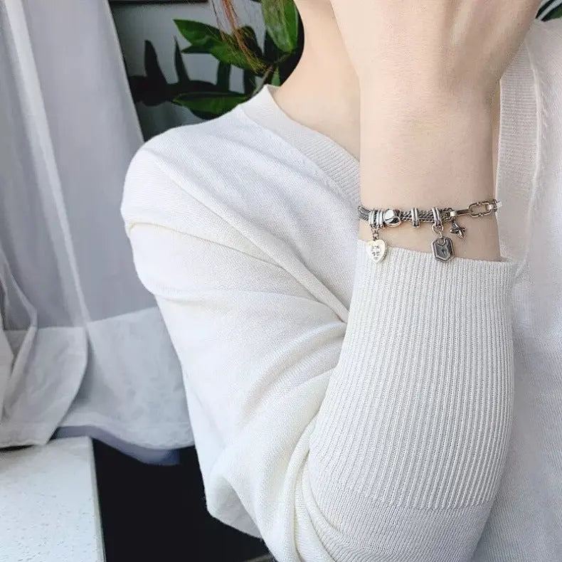 CROSS CHARM LAYERED BRACELET Mira Gemini